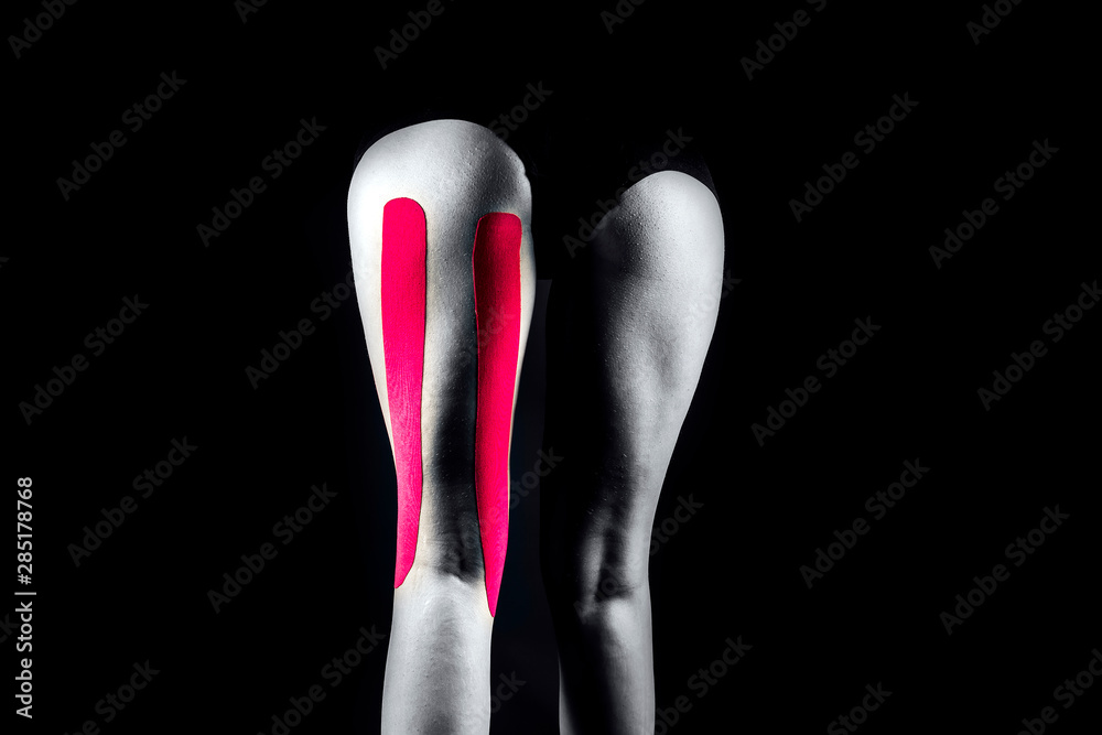 Medical taping for hamstrings pain relief showed on young model. Medical taping for hamstrings pain relief showed on young model.