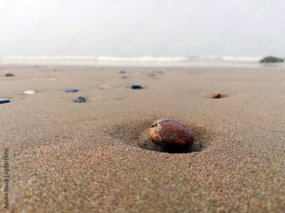 Beautiful beach with a colorful pebbles in sand Beautiful beach with a colorful pebbles in sand