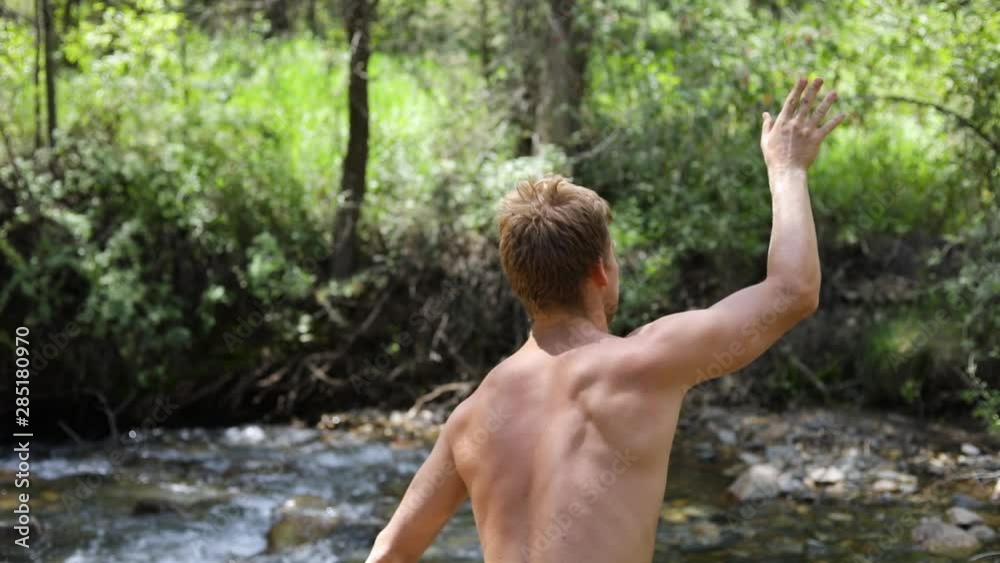 Slow motion shot of a shirtless man practicing his axe throwing skill by trying to throw his hatchet at a pine tree. Slow motion shot of a shirtless man practicing his axe throwing skill by trying to throw his hatchet at a pine tree.