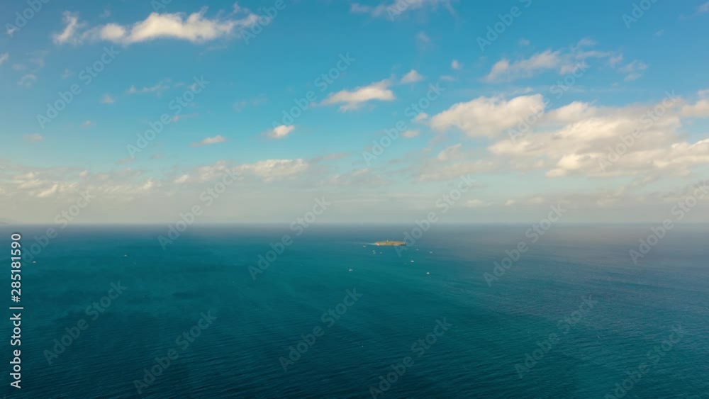 Time lapse: Blue sky with clouds over the sea and island Pescador, aerial view. Seascape: Ocean and sky, Cebu, Philippines. Time lapse: Blue sky with clouds over the sea and island Pescador, aerial view. Seascape: Ocean and sky, Cebu, Philippines.