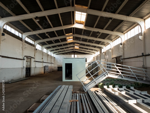 Interior of the old warehouse with piled construction materials