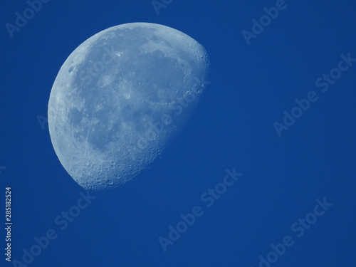 a very dense close-up of a decreasing moon in the morning sky