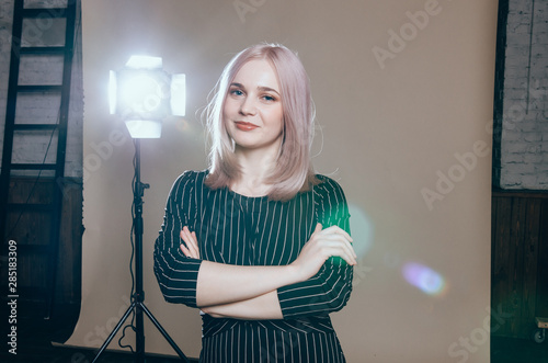 Fashion art portrait of a female model at studio in the light flashes