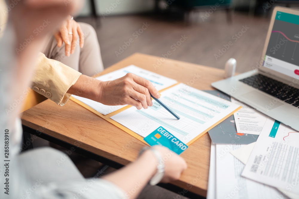 Hands of two Caucasian female business partners sitting at the table Hands of two Caucasian female business partners sitting at the table