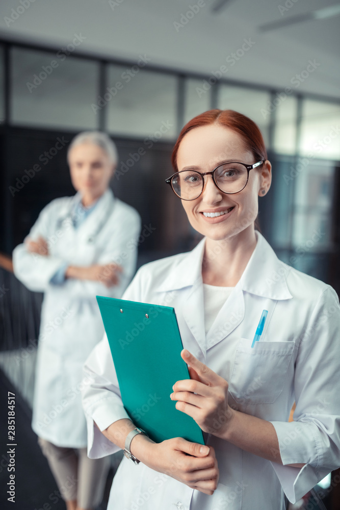 Smiling female doctor looking in front of her Smiling female doctor looking in front of her
