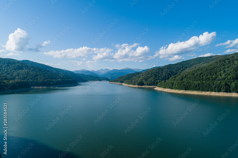 Aerial top view on a Fagaras mountains  surrounding Vidraru dam with a reservoir lake
