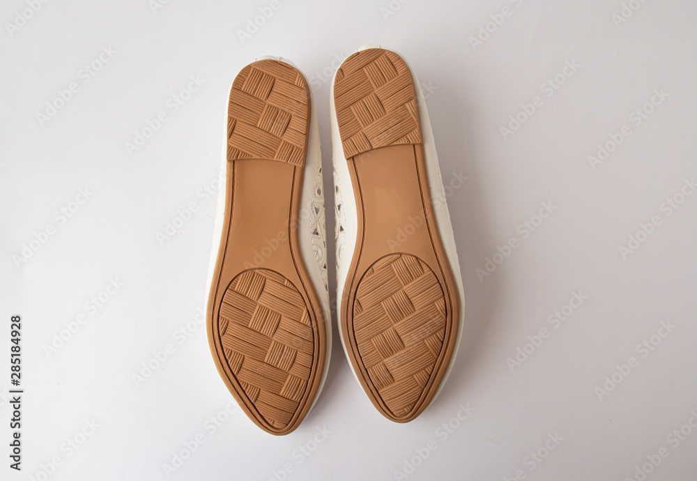 Fototapeta premium White couple with embroidered ballet shoes. On a white background, sole