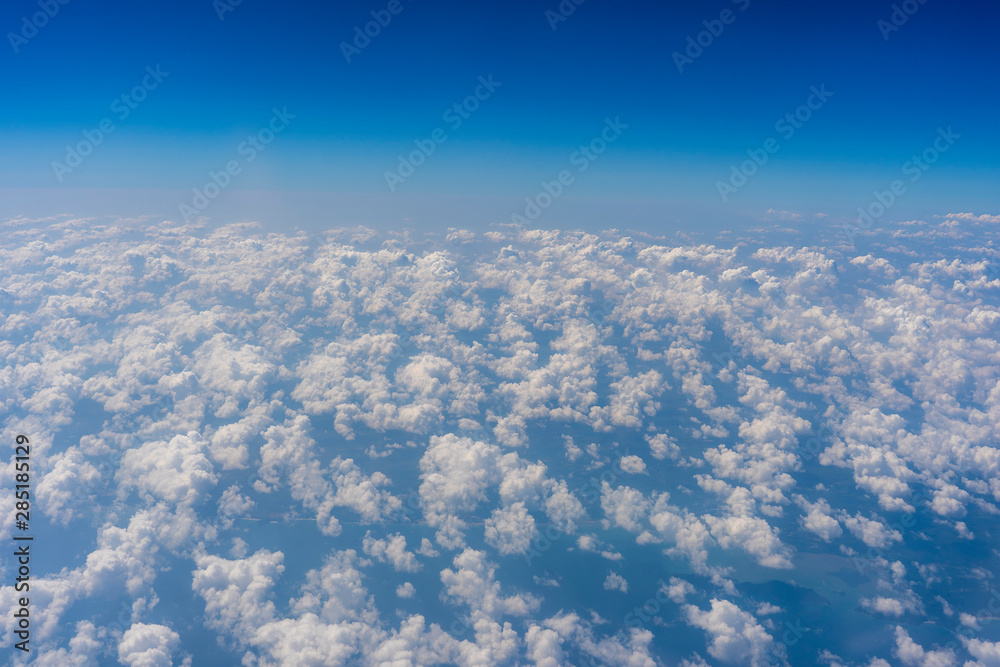 White clouds and blue sky, a view from airplane window White clouds and blue sky, a view from airplane window