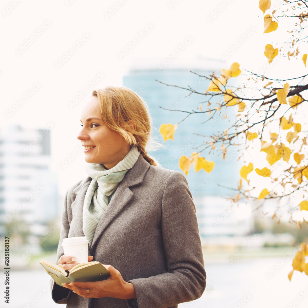 Smart pretty woman in autumn park