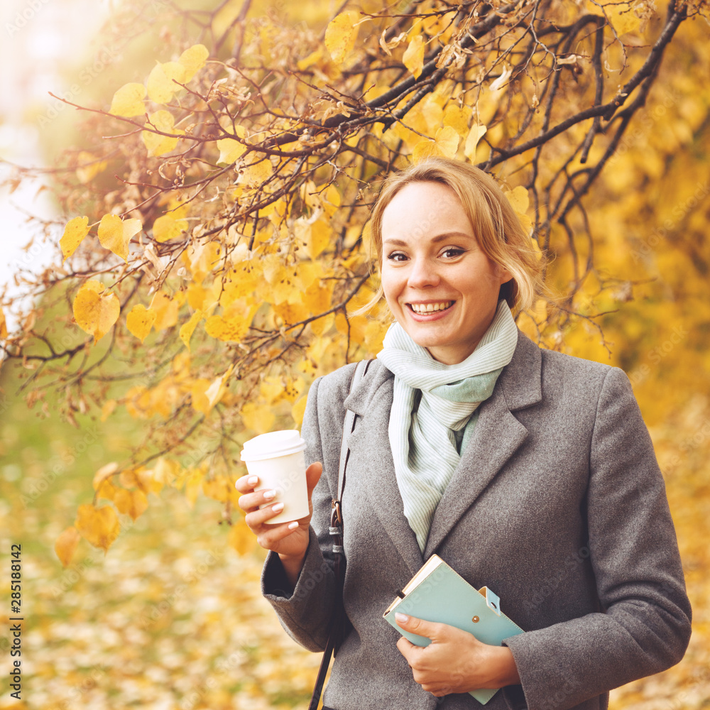 Young smiling woman in autumn park