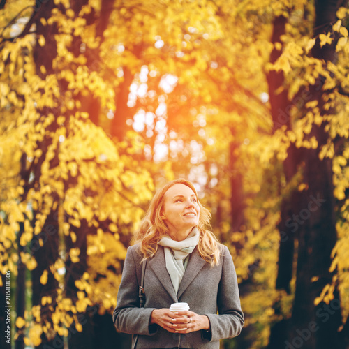 Young pretty woman walking in the autumn park