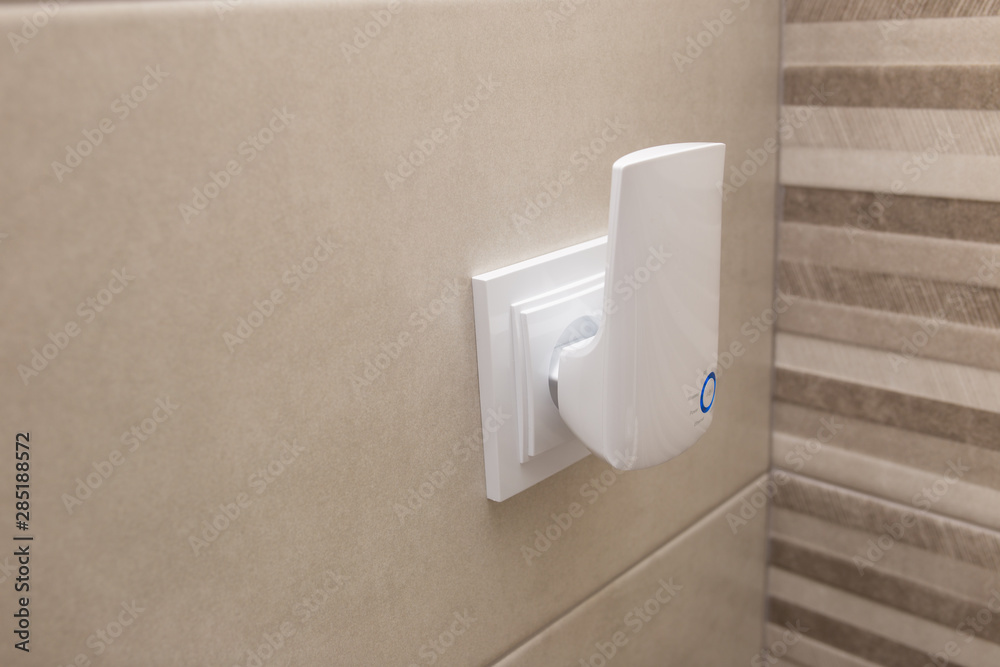 Αυτοκόλλητο Wifi home repeater plugged in closeup.