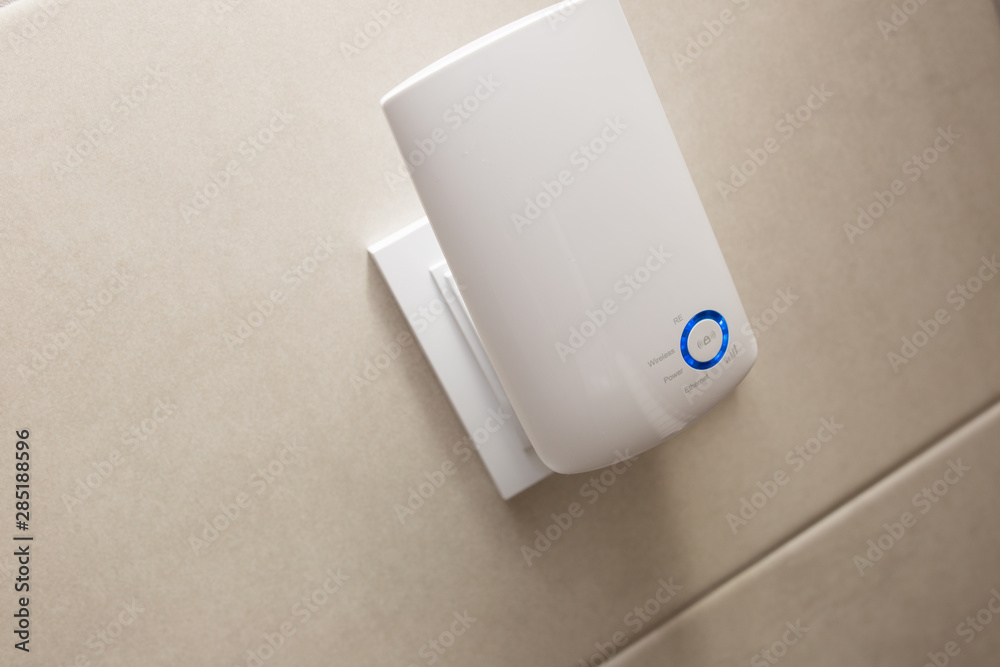 Fotografie Wifi home repeater plugged in closeup.
