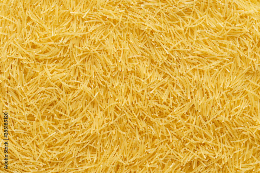 Dry uncooked vermicelli pasta as a background. Dry uncooked vermicelli pasta as a background.