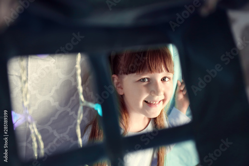 Cute little girl sitting in...