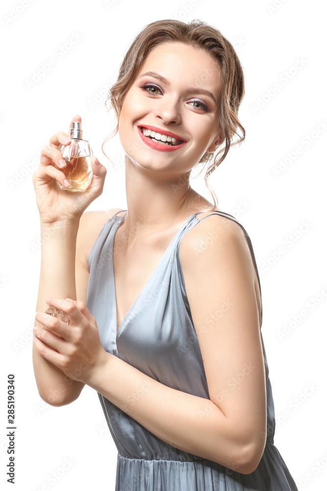 Beautiful young woman with bottle of perfume on white background Beautiful young woman with bottle of perfume on white background