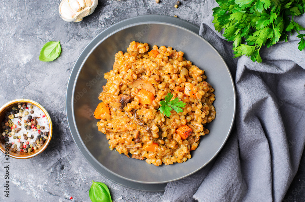 Spelt Pumpkin Mushroom Risotto on Grey Background, Vegetarian Meal Spelt Pumpkin Mushroom Risotto on Grey Background, Vegetarian Meal