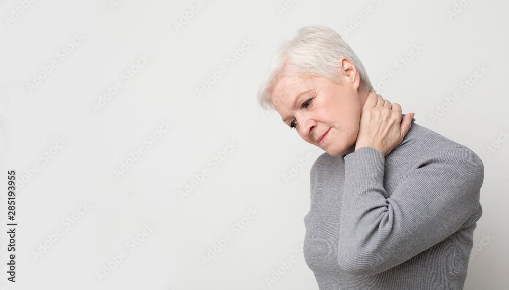 Senior woman suffering from neck pain and feeling exhausted Senior woman suffering from neck pain and feeling exhausted