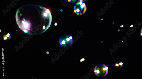 Blurred beautiful soap bubbles on a dark background