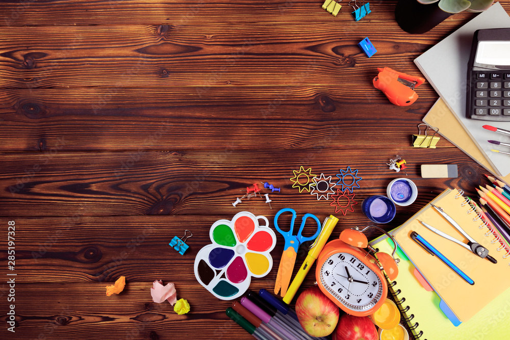 Fototapeta premium Back to School background concept. School supplies on a wooden background. Education background concept with copyspace.Top view. Back to school - Image