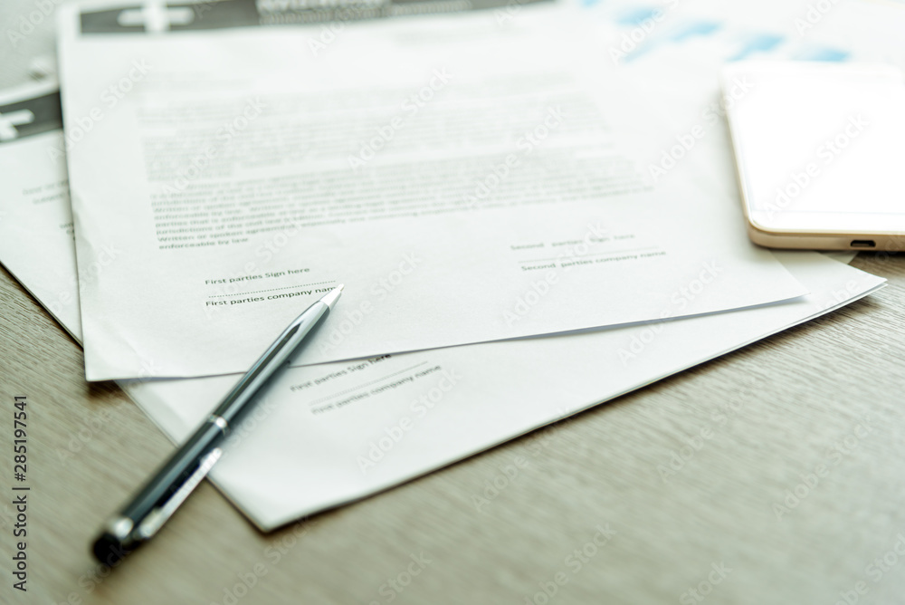 Business Legal Contract signing Concept. Close-up of pen on contract business document with lighting on desk.nobody Business Legal Contract signing Concept. Close-up of pen on contract business document with lighting on desk.nobody