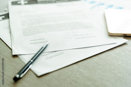 Business Legal Contract signing Concept. Close-up of pen on contract business document with lighting on desk.nobody