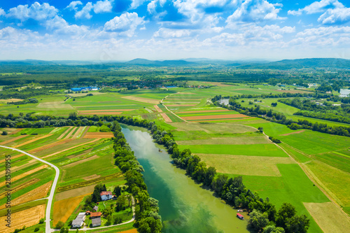 Rural countryside landscape in Croatia, confluence of Korana and Kupa rivers between agriculture fields and villages, panoramic view from drone  © ilijaa