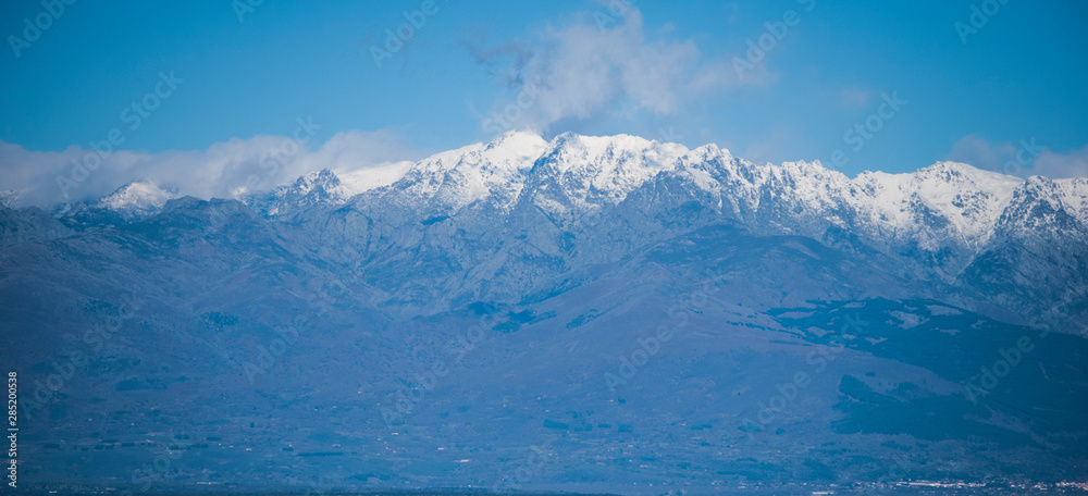 View of the mountains on a clear winter day where the blue sky and mountains predominate