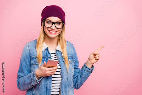 Photo of gorgeous toothy charming girlfriend pointing at your right choice after having advised you best service center while isolated with pastel background