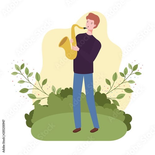 man with saxophone and branches and leaves in the background