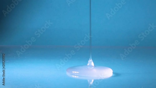 Transparent liquid, shower gel, hyaluronic acid, liquid glass slowly pour to the surface.