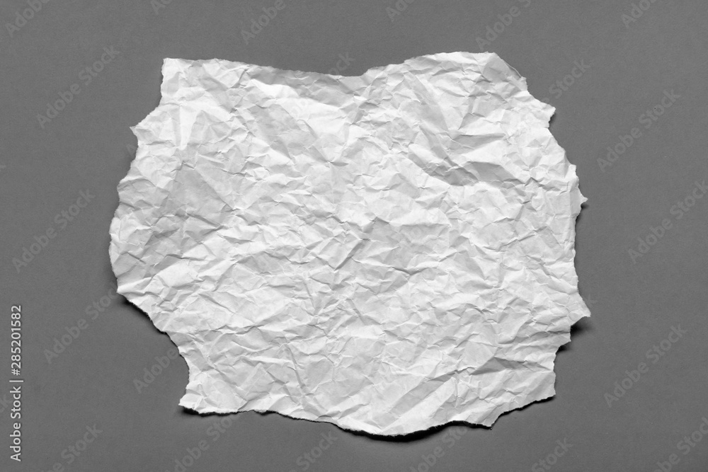 Modern crumpled white paper on empty sheet gray background with light shadows for creative wallpaper, card, art work design. Modern crumpled white paper on empty sheet gray background with light shadows for creative wallpaper, card, art work design.