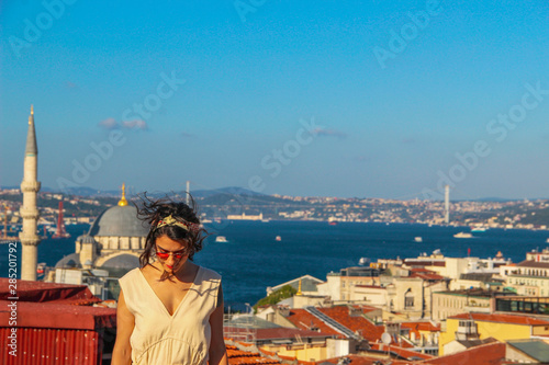 Photography Eurasian woman standing at the roof with bosphorus background in Istanbul, Turke