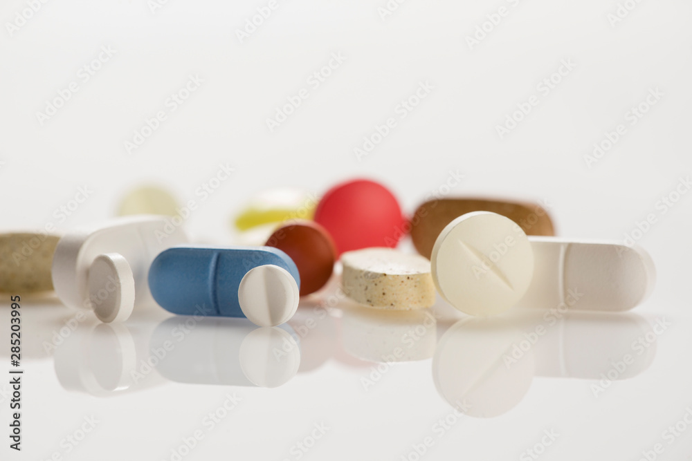 Pile of medical tablets isolated on white background. Closeup. Pile of medical tablets isolated on white background. Closeup.