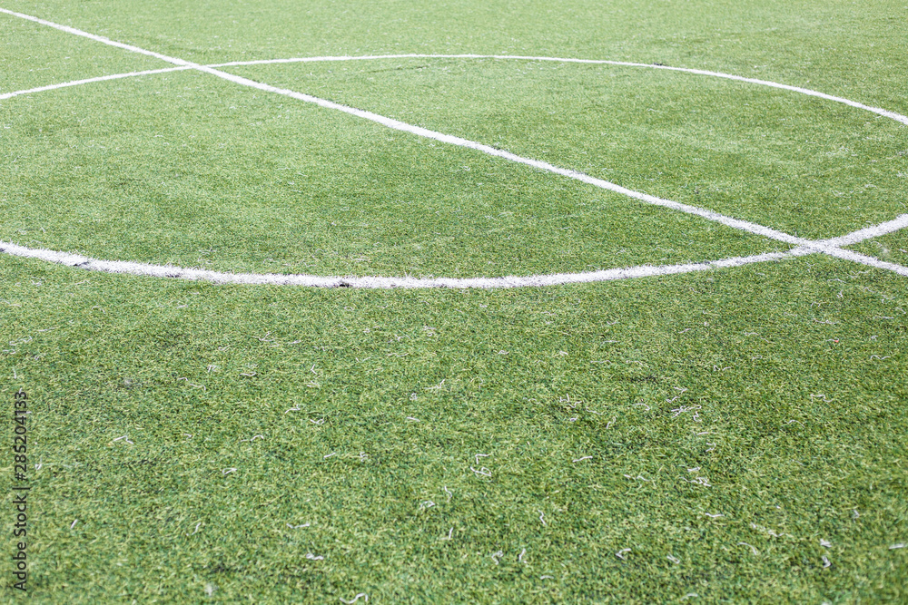 Obraz premium Football field with green cover. White markings on the field. Ball Cover.