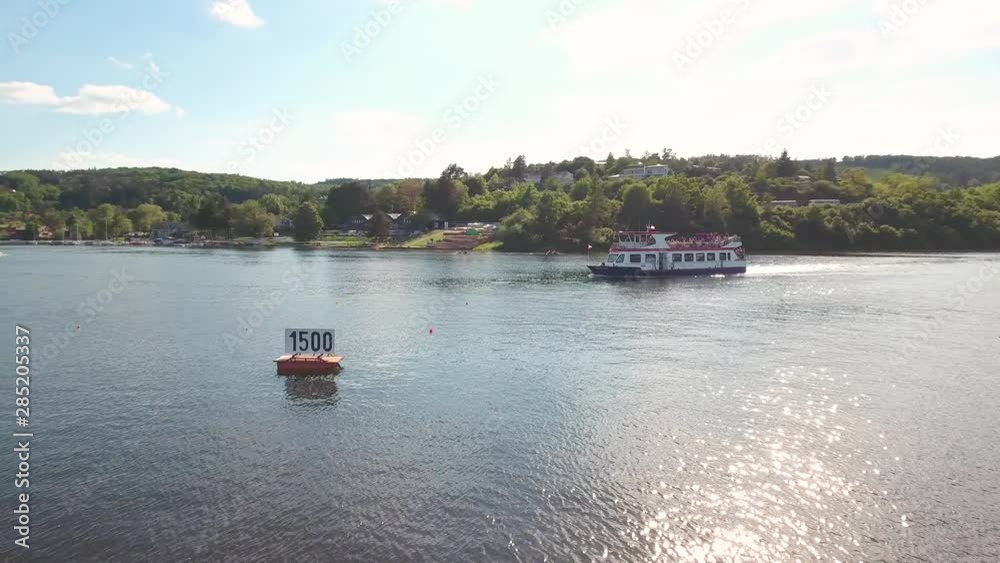 Aerial view of ferry with tourists on the lake, sunny day Aerial view of ferry with tourists on the lake, sunny day