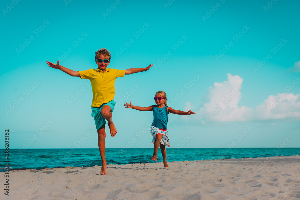 happy cute boy and girl play on beach happy cute boy and girl play on beach