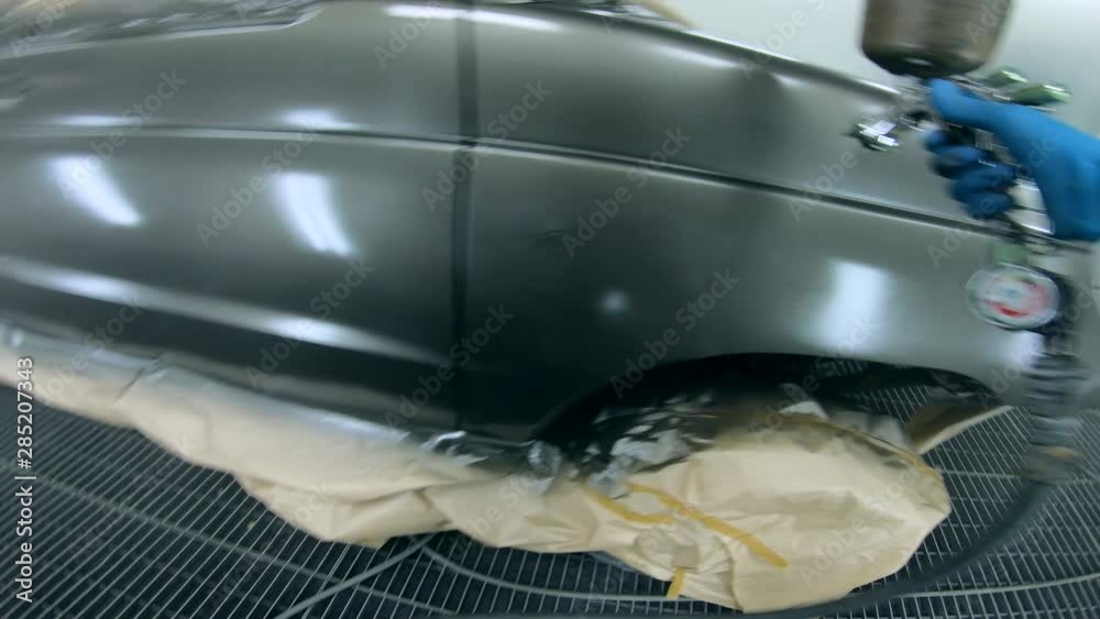 Car's surface is getting spray-painted