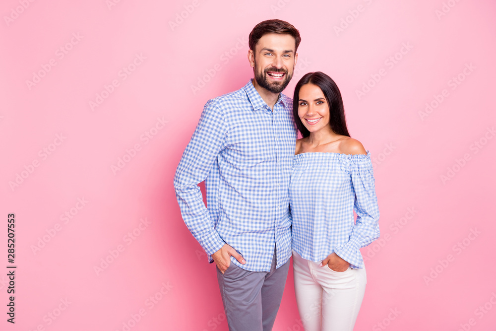 Portrait of charming sweethearts looking at camera with toothy smile isolated over pink background Portrait of charming sweethearts looking at camera with toothy smile isolated over pink background