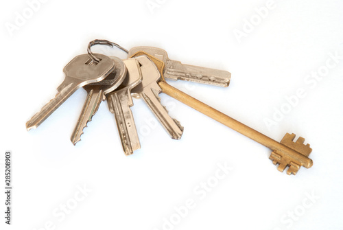 A bunch of modern door keys on ring on white background