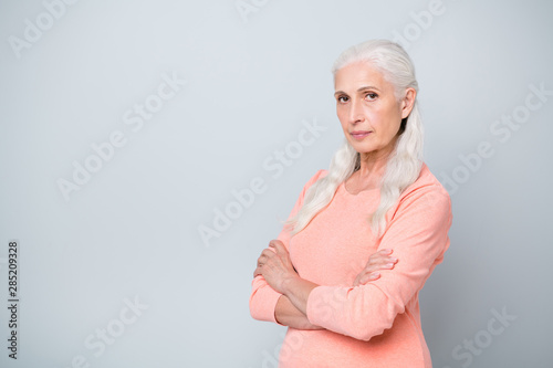 Photo of modern serious not smiling lady holding her arms folded wearing peach color pullover isolated grey background