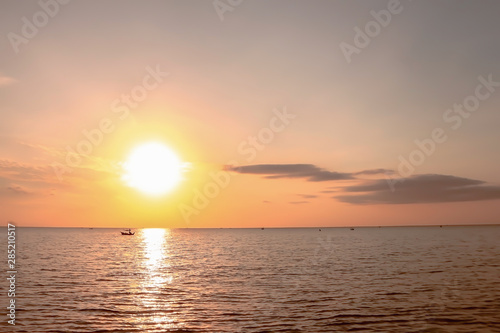 Beautiful dramatic atmosphere of twilight sky and sea with fisherman's boats in summer tropical season.