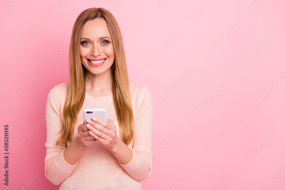 Portrait of cute millennial hold hand modern technology isolated over pink background Portrait of cute millennial hold hand modern technology isolated over pink background
