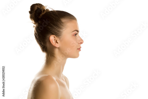 Profile of young beautiful shirtles woman on white background photo