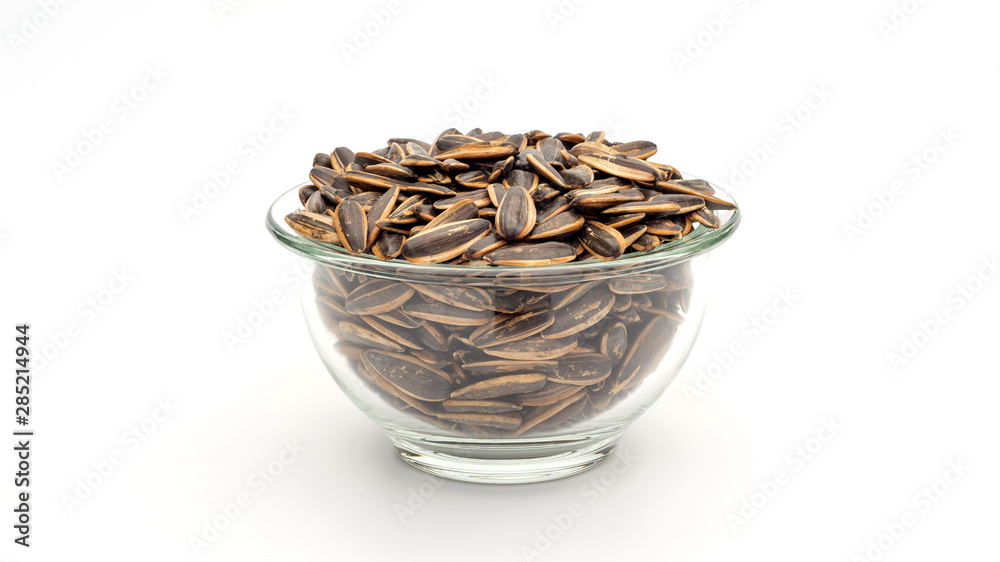 Sunflower seed in a bowl on a white background.