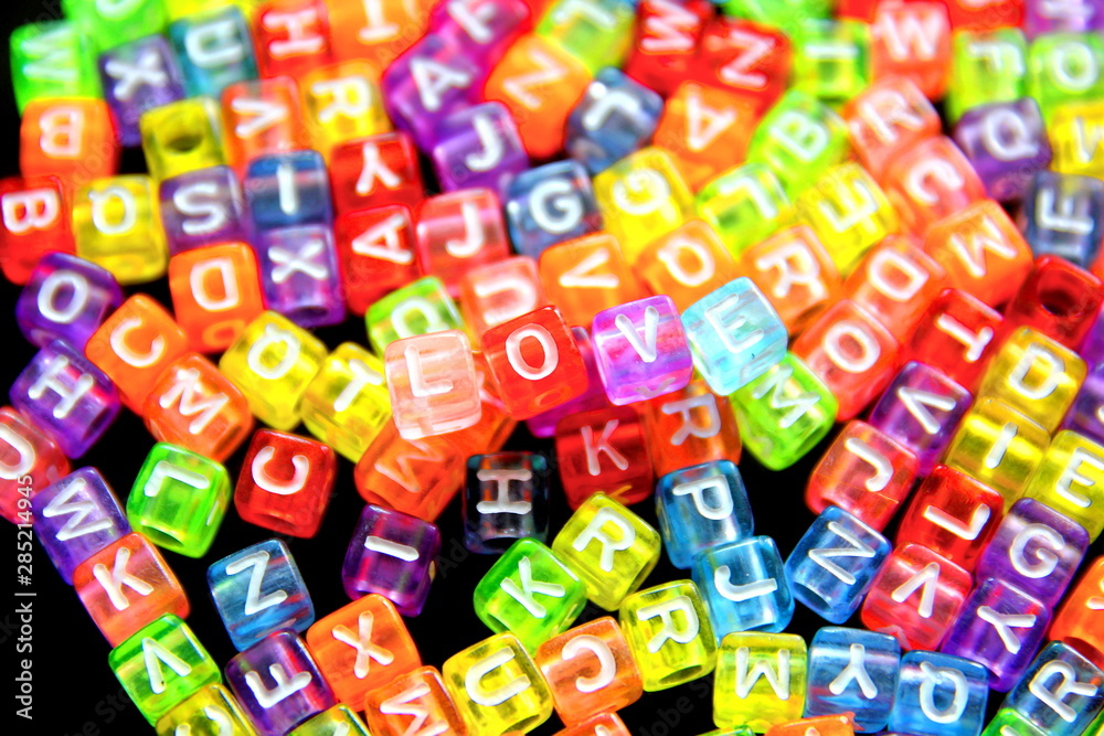 LOVE Engish letter on colorful cubic beads isolate on black background. LOVE Engish letter on colorful cubic beads isolate on black background.