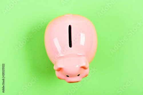 income management. planning budget. financial problem. piggy bank on green background. money saving. top view of money box. empty moneybox. moneybox with slot. you have nothing