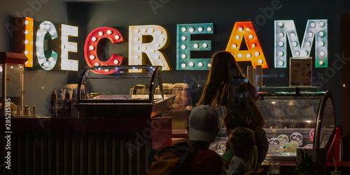 Family Buying Ice Cream From a Shop  photo