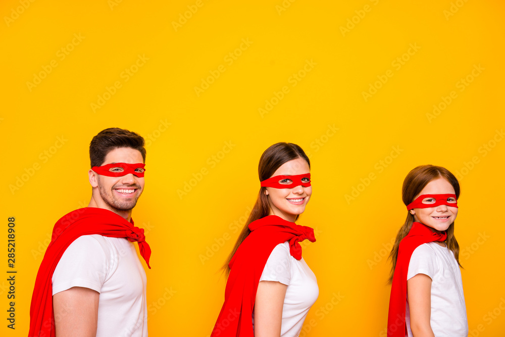 Photo of family cartoon characters carnival participants wear superhero capes isolated yellow background Photo of family cartoon characters carnival participants wear superhero capes isolated yellow background