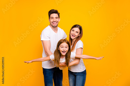 Photo of three family members spending leisure time playing games wear casual outfit isolated yellow background